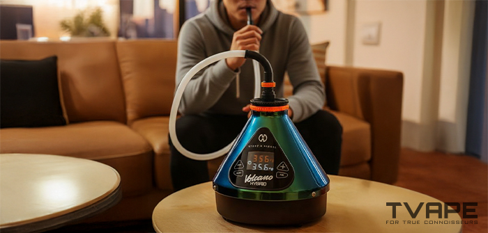 Ein Mann inhaliert aus dem Volcano Hybrid Desktop-Vaporizer (Evergreen Edition).